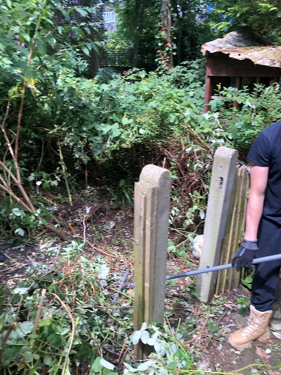 Concrete posts and ground visible again after clearing