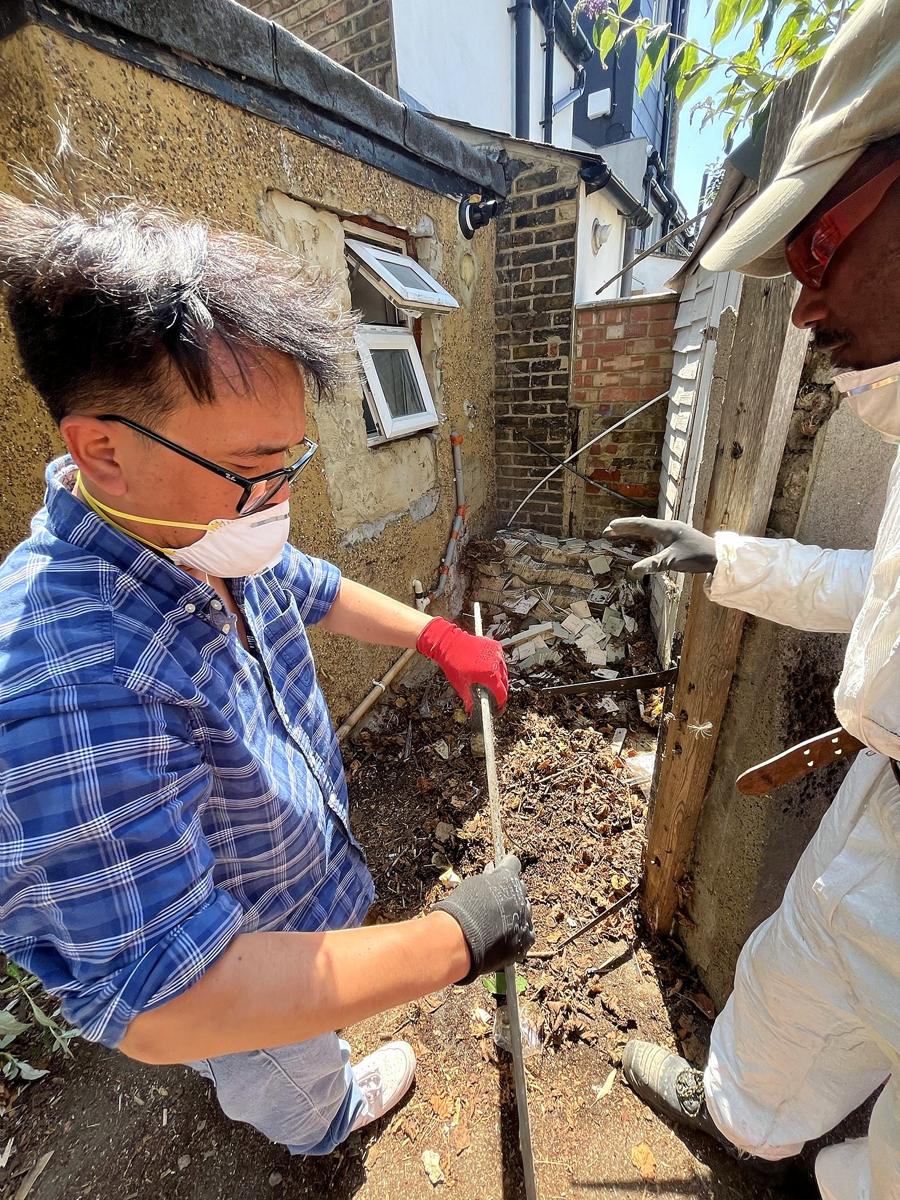 Crew shovelling rubble in the side return
