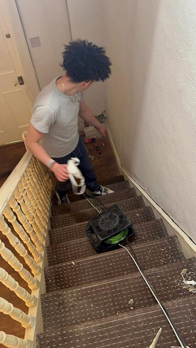 Stair carpet being stripped indoors