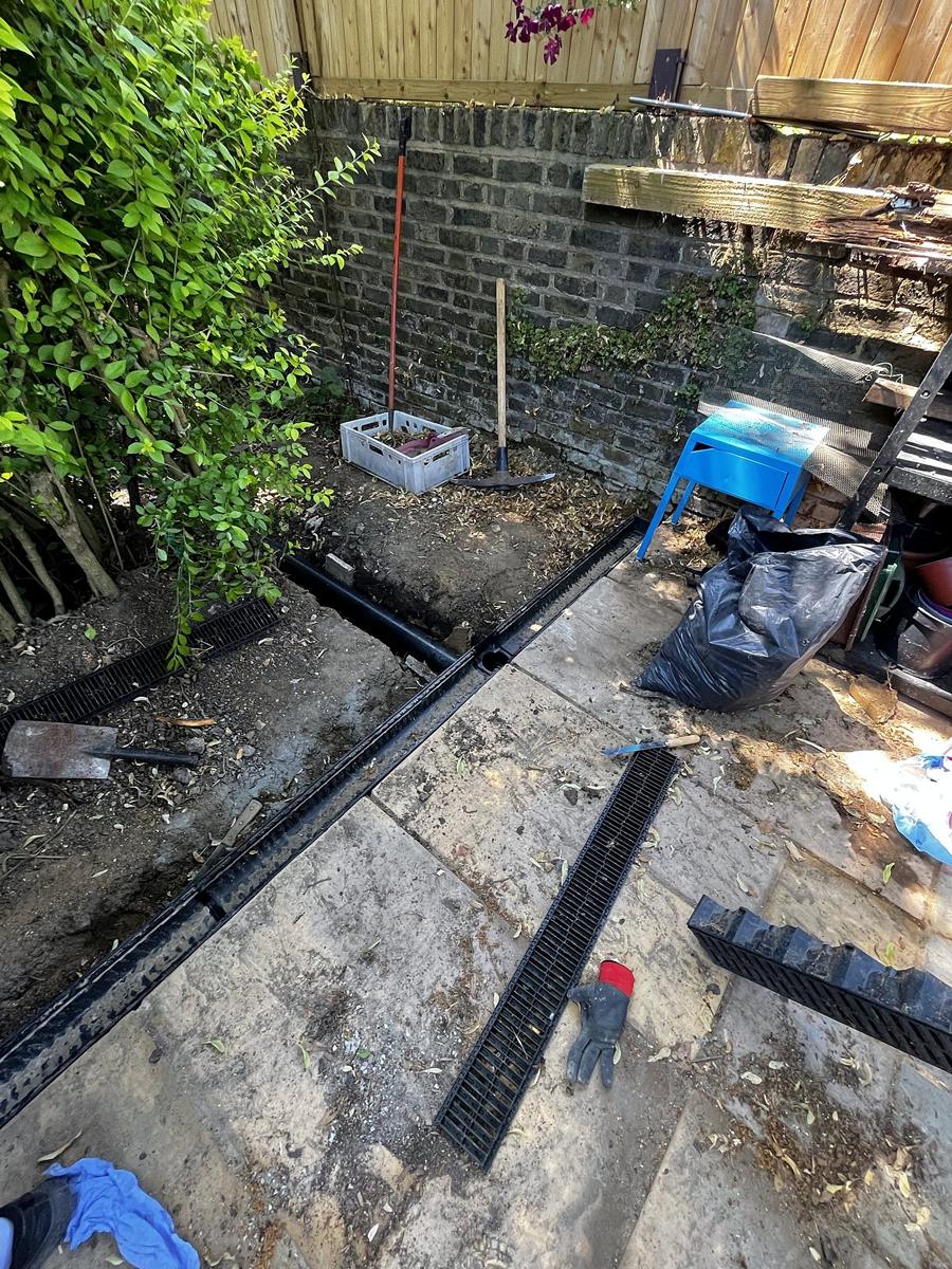 Drainage channels being fitted along the patio